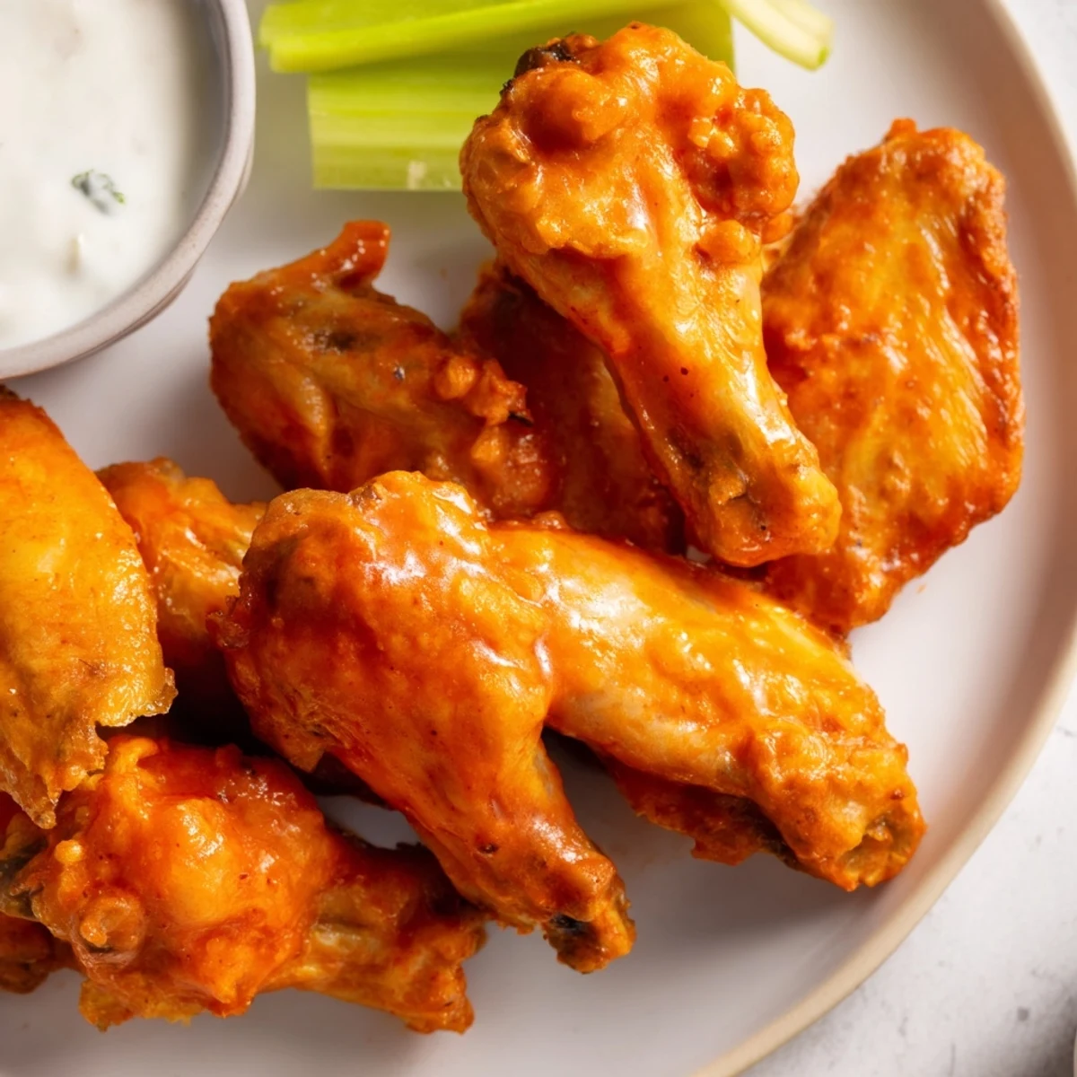 Golden-brown Buffalo Wings tossed in tangy red sauce, served with celery and blue cheese dip.