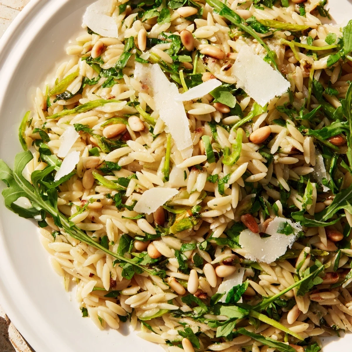 This chilled Asparagus Lemon Orzo Salad features crisp asparagus ribbons, toasted pine nuts, and fresh herbs for a refreshing spring side dish.