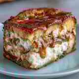 Slices of Caramel Cream Cheese Bread reveal a moist crumb and ribbon of caramel on a rustic serving board.