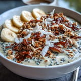 Vibrant, thick high fiber smoothie bowl, ready to enjoy with seeds and coconut.
