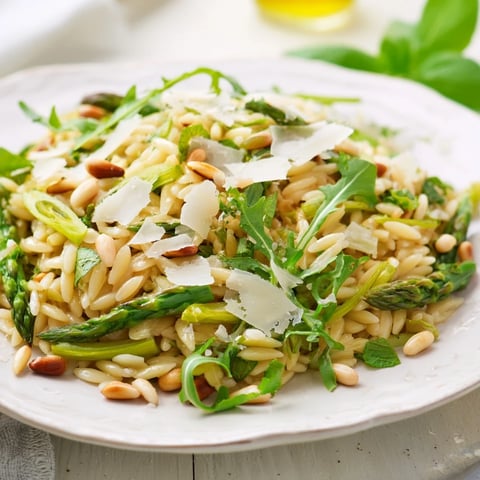 Bright shaved asparagus and tender orzo shine in this Asparagus Lemon Orzo Salad, drizzled with zesty lemon dressing and topped with Parmesan.
