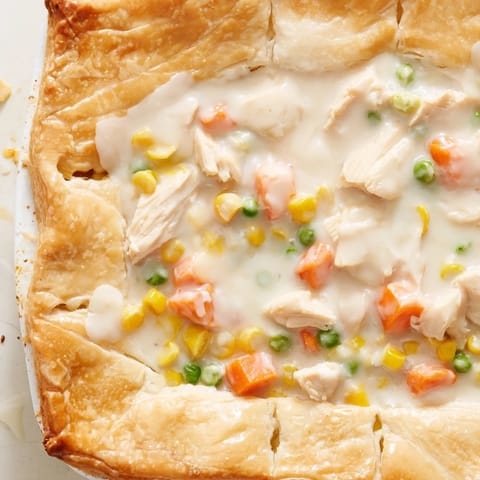 Sliced Chicken Pot Pie revealing a rich, savory filling of tender chicken and vegetables inside.