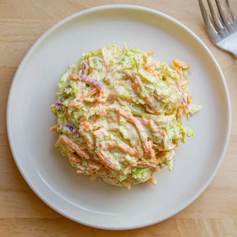 Chilled Coleslaw served as a perfect side dish at a summer backyard barbecue with pulled pork.
