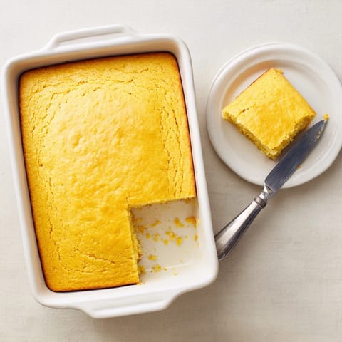A rustic square of homemade Cornbread reveals a tender, moist crumb and buttery edges, perfect alongside a bowl of chili.