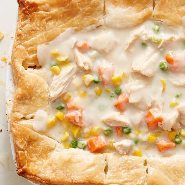 Sliced Chicken Pot Pie revealing a rich, savory filling of tender chicken and vegetables inside.
