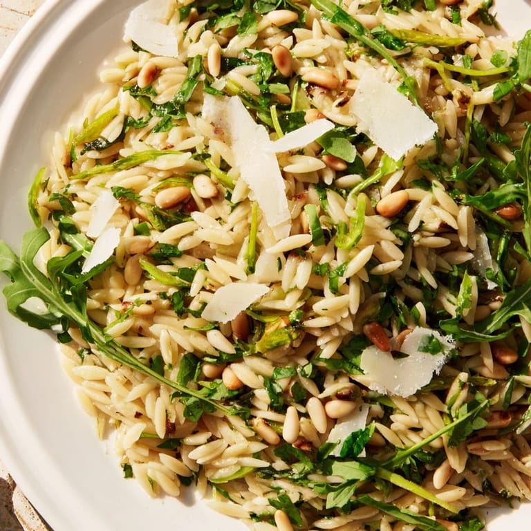 This chilled Asparagus Lemon Orzo Salad features crisp asparagus ribbons, toasted pine nuts, and fresh herbs for a refreshing spring side dish.